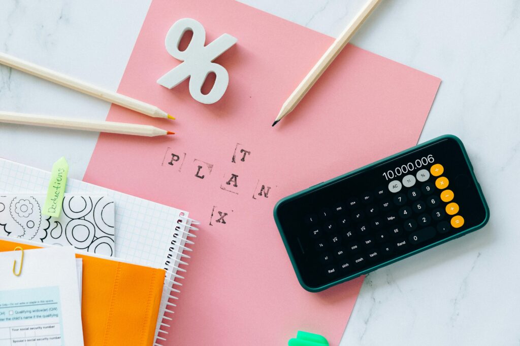 pexels-photo-6863514-6863514 Flat lay showing tax planning tools including a calculator, pencils, and stationery items.